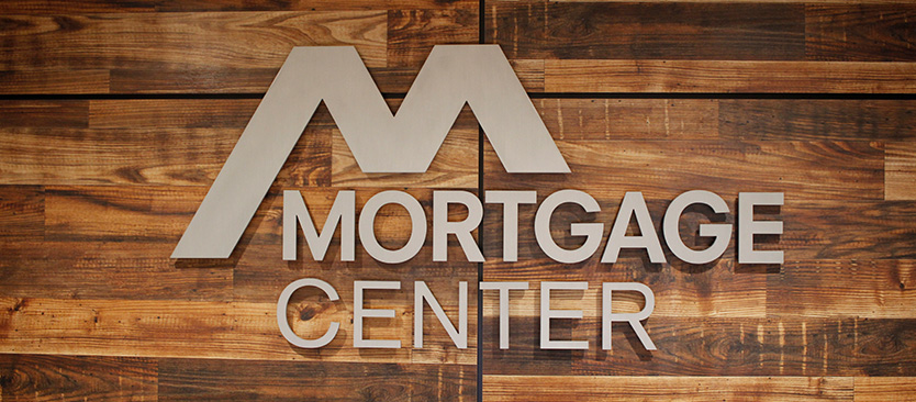 Mortgage Center logo against wood wall