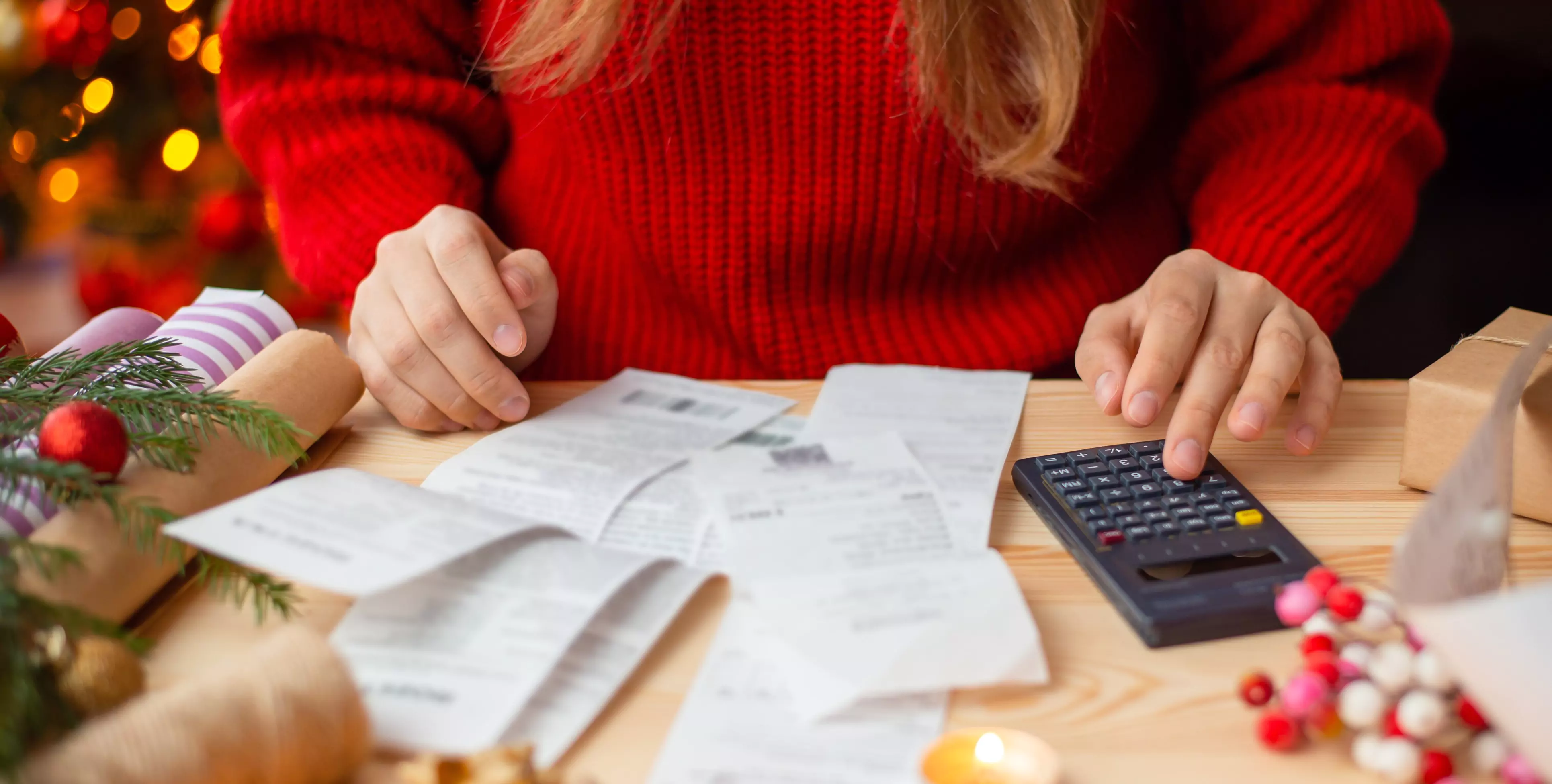 person with calculator figuring out holiday debt