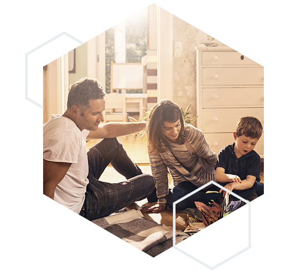 image of a family reading a book on the floor within a hexagon